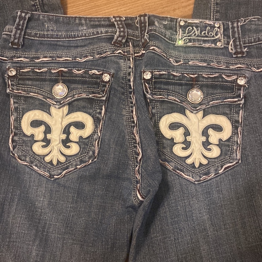Fleur de Lis and embellished blue jeans